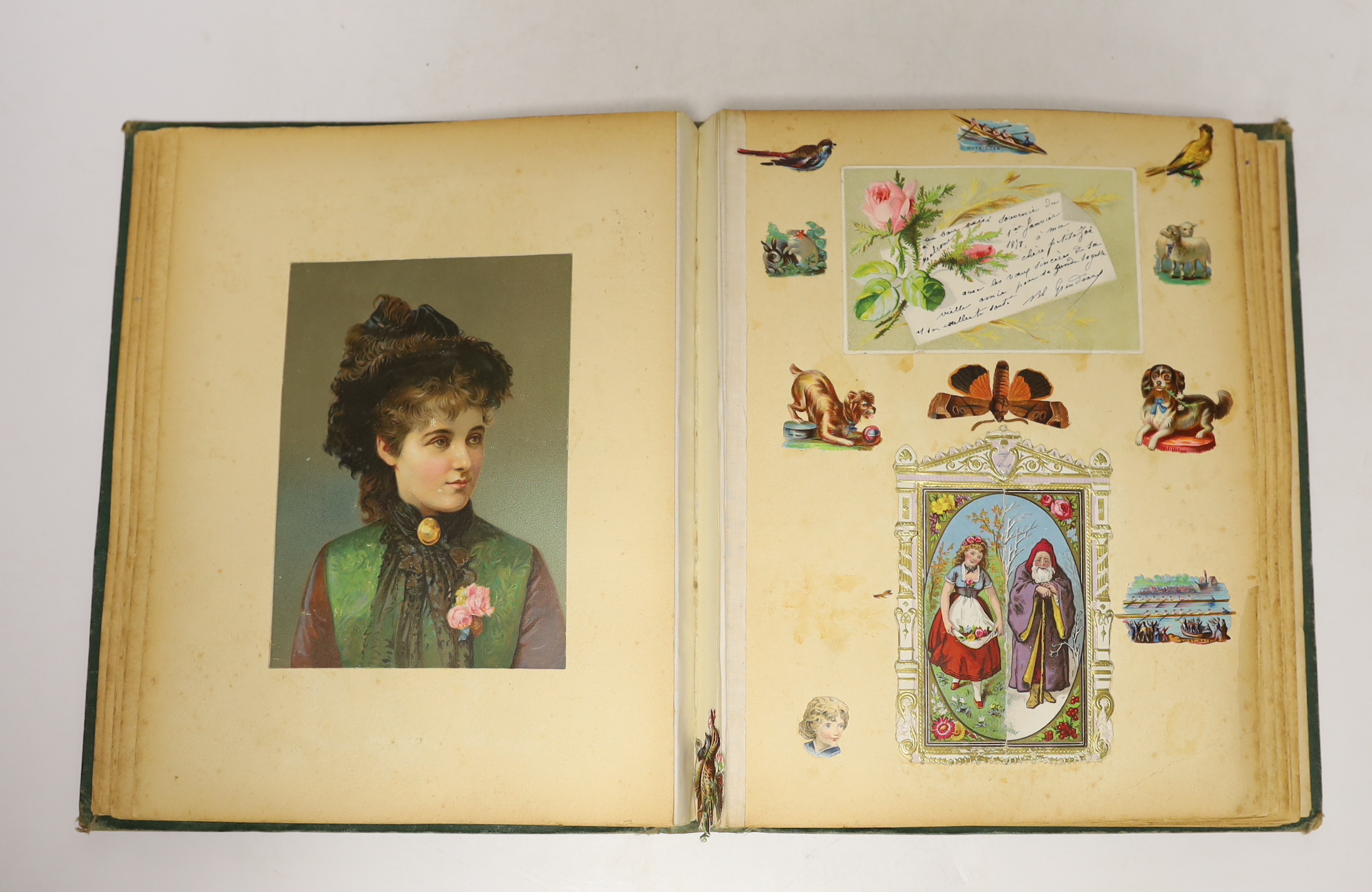 A Victorian scrap album, containing chromolithographic cards and scraps and pressed leaves and two other items